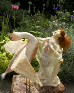 Re-emerging sculture by Corina Duyn Sculpture of bird and female figure dancing in a garden, ME/CFS Artist and Writer Corina Duyn